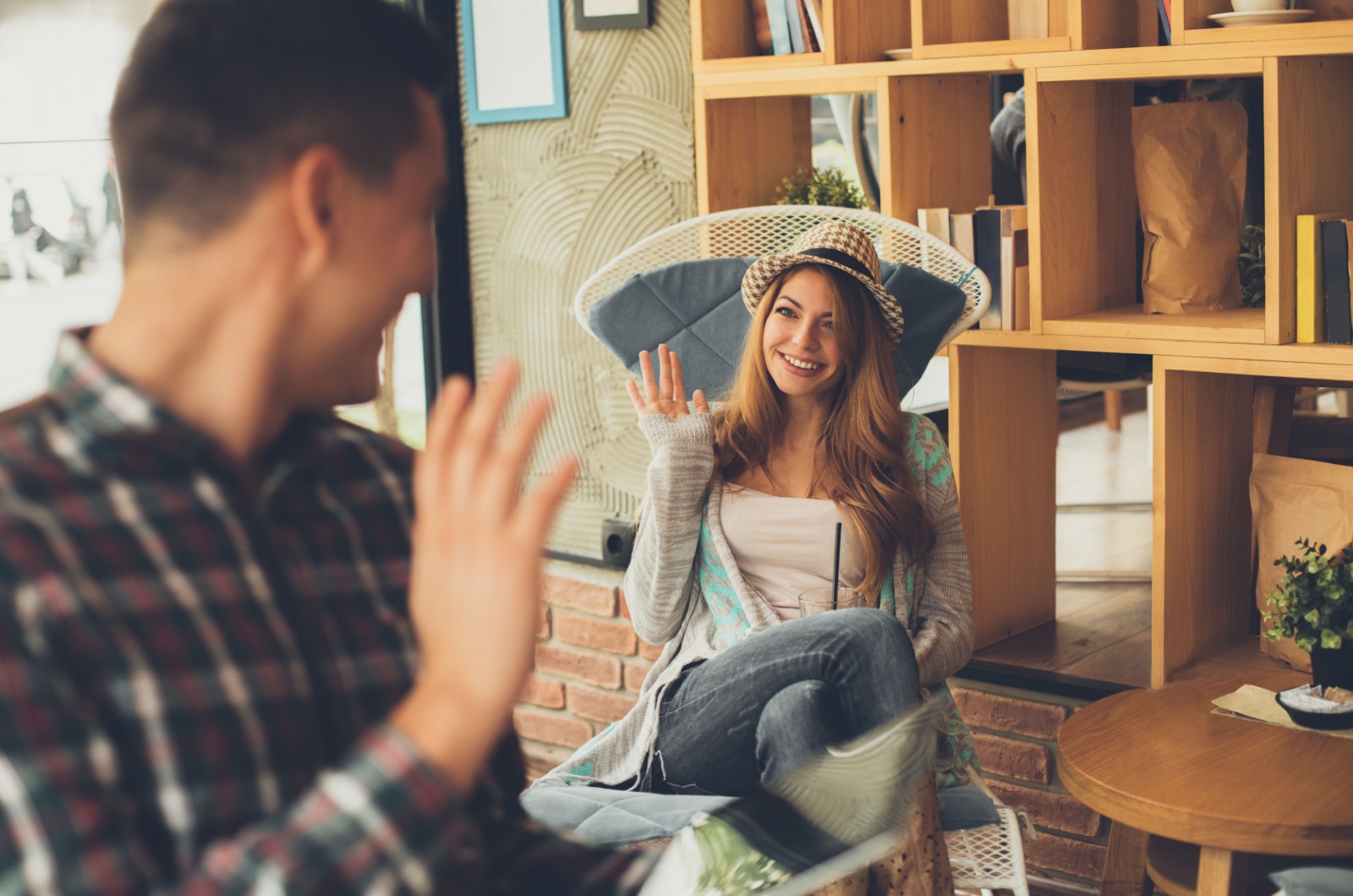 woman waving to a man