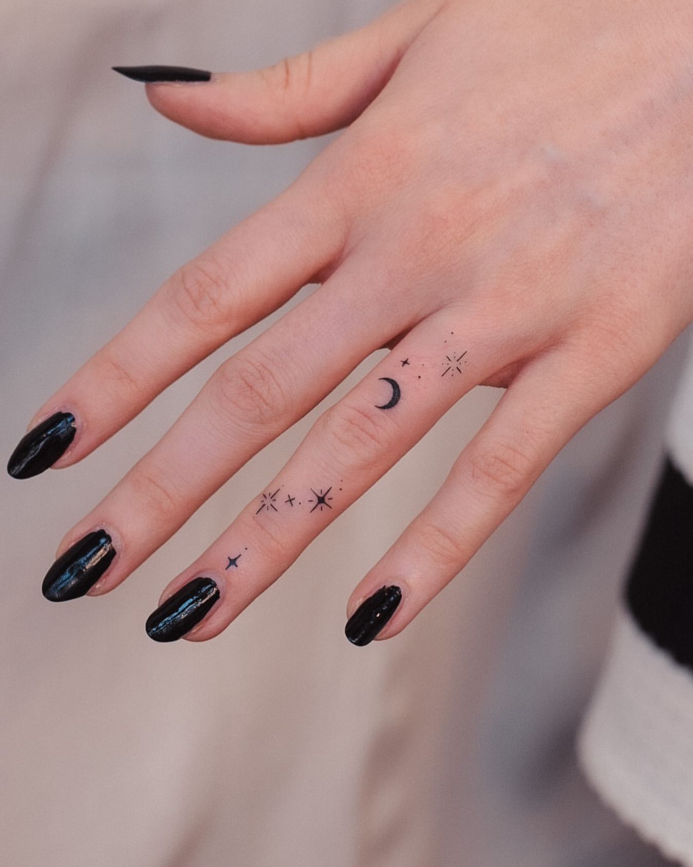 tiny stars finger tattoo