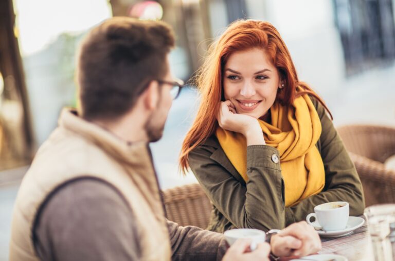woman smiling and listening to man