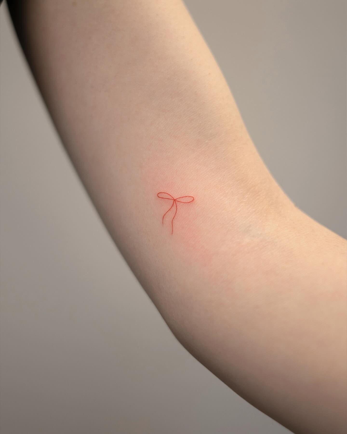 tiny bow tattoo