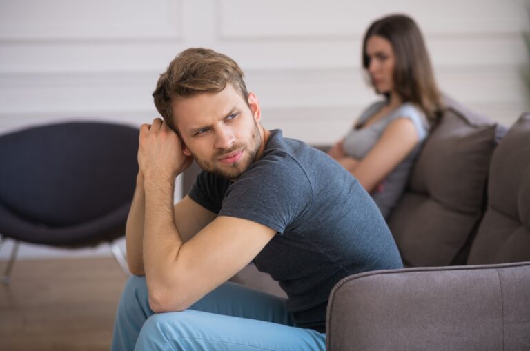 worried man sitting next to girlfriend
