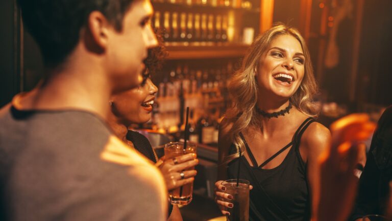 woman laughing in a bar