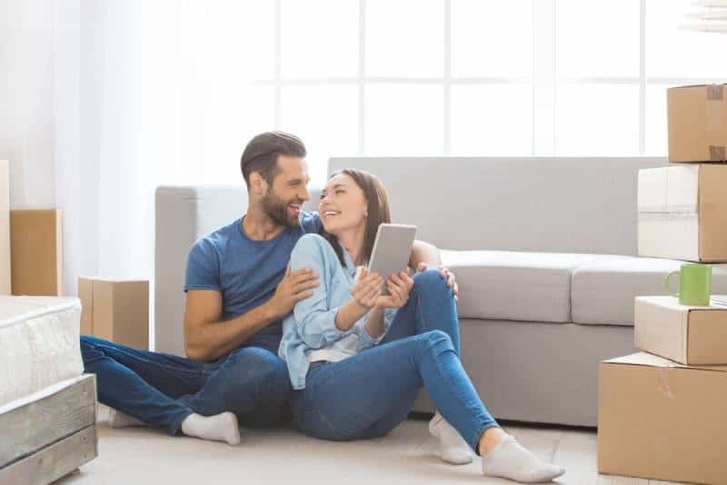 couple sitting on the floor in a new home