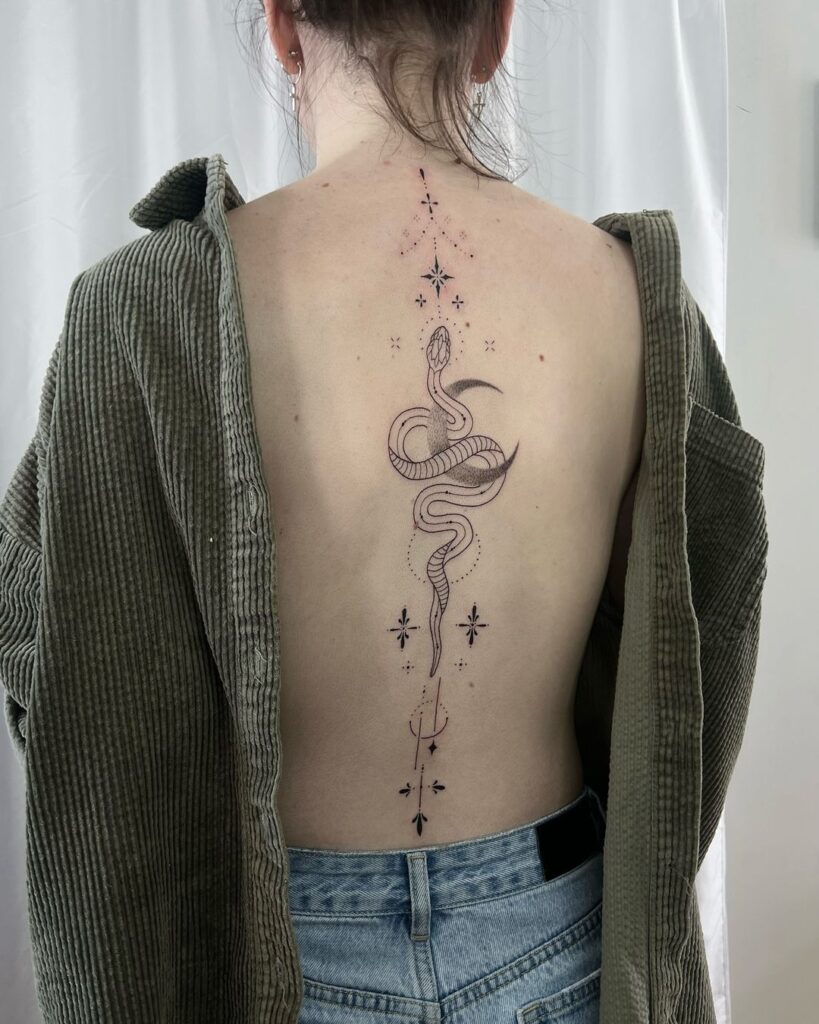 fine line deity ornamental spine tattoo with a snake