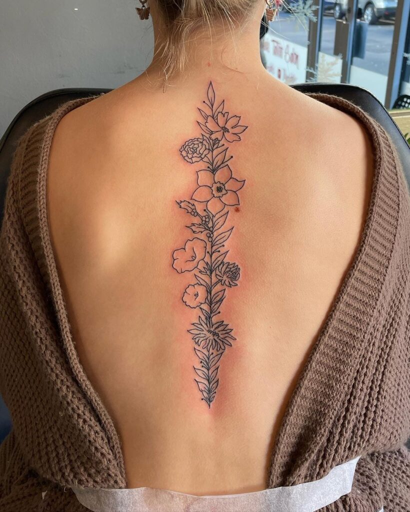 floral fine line spine tattoo
