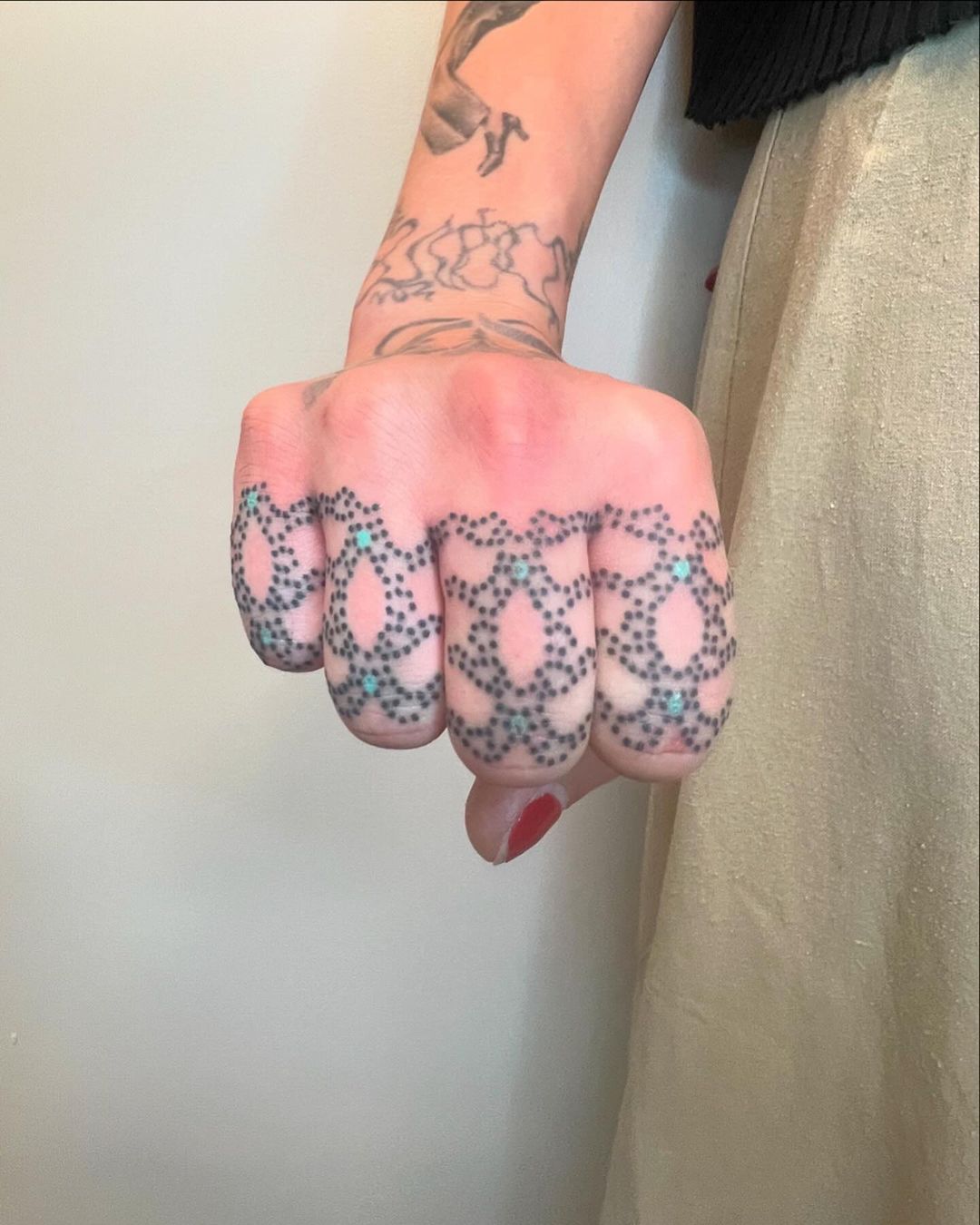 four finger ornamental shield tattoo