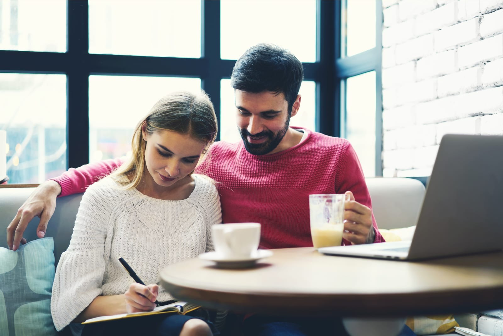 man watching at woman writing