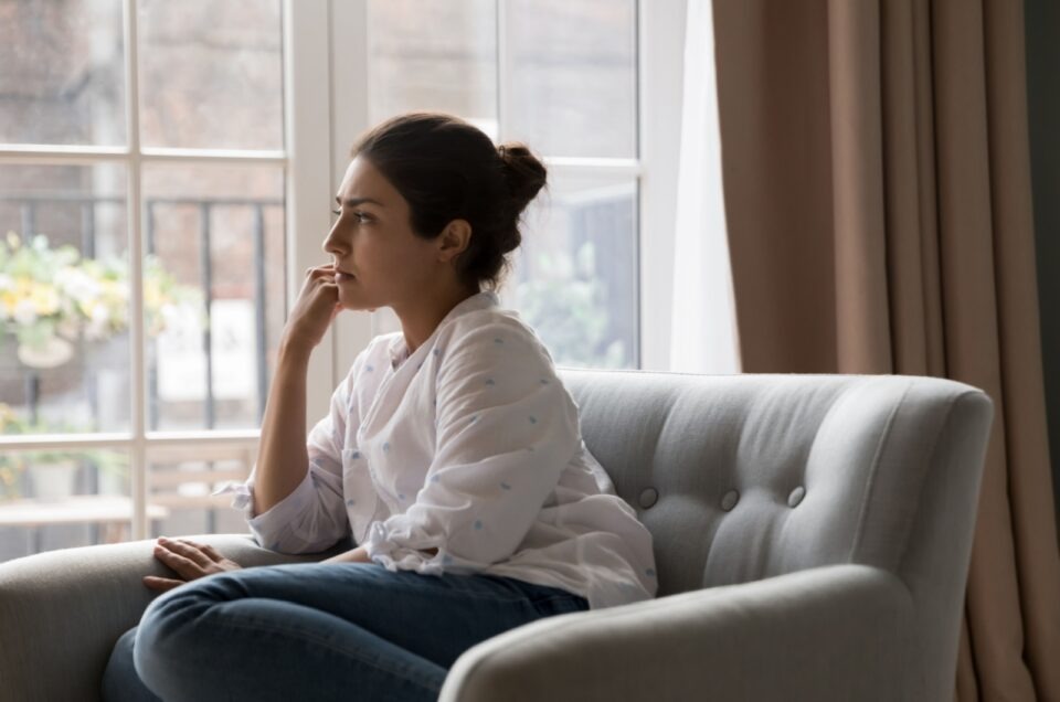 mindful woman sitting in sofa