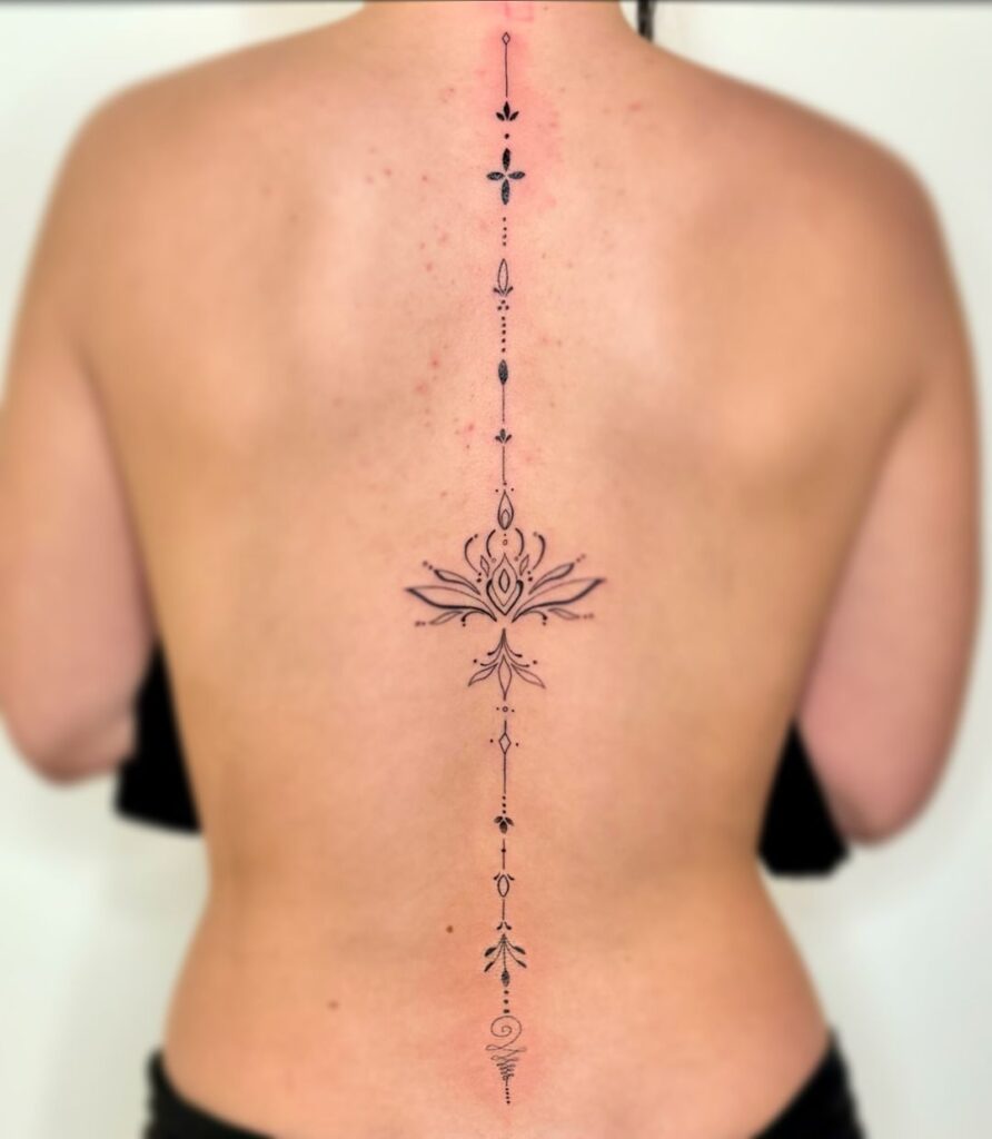 tatuaje ornamental de línea fina en la columna vertebral
