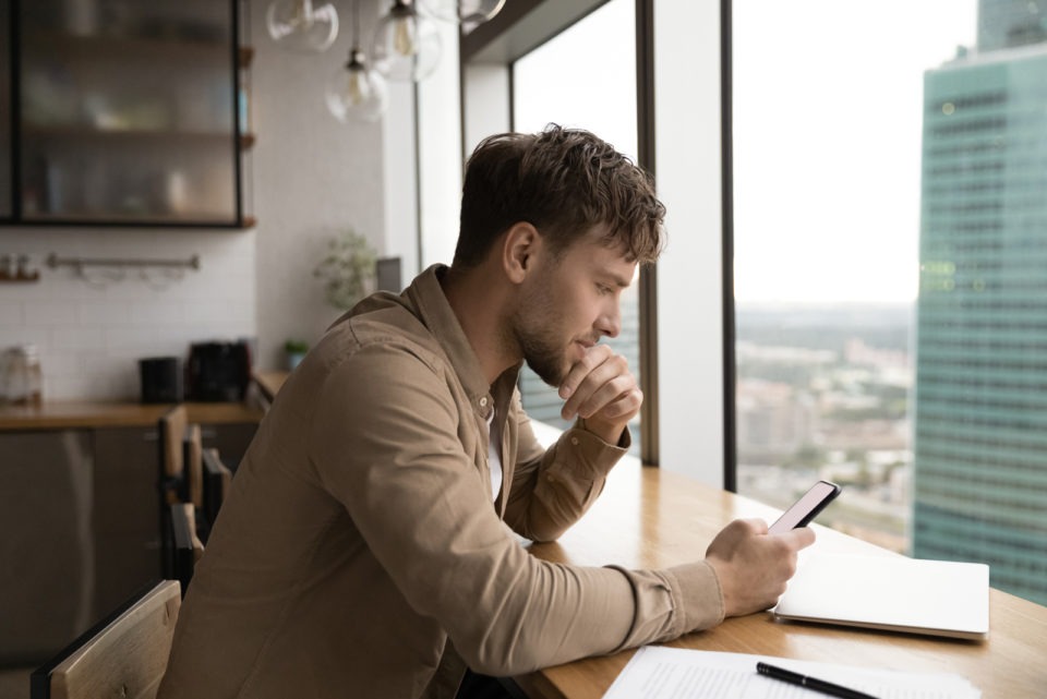 pensive man looking at phone