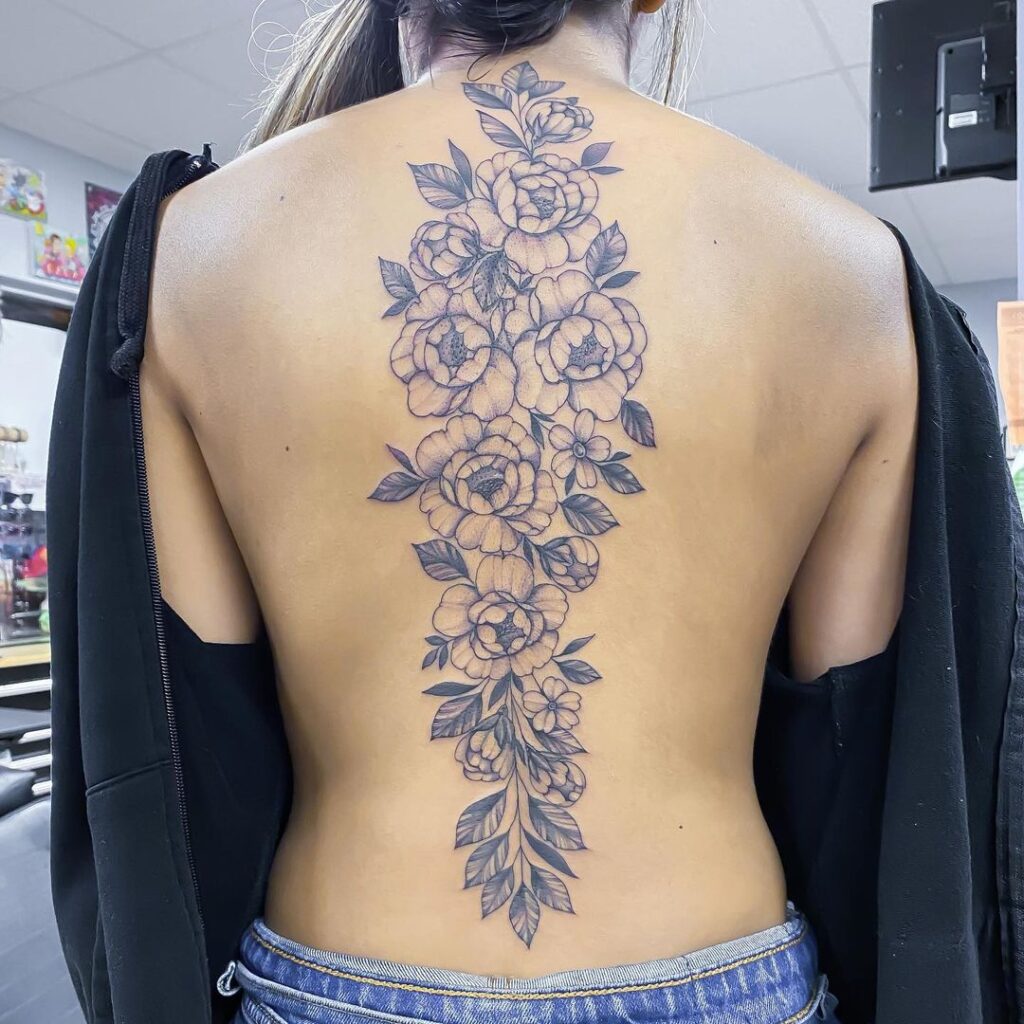 peony spine tattoo with gray shading