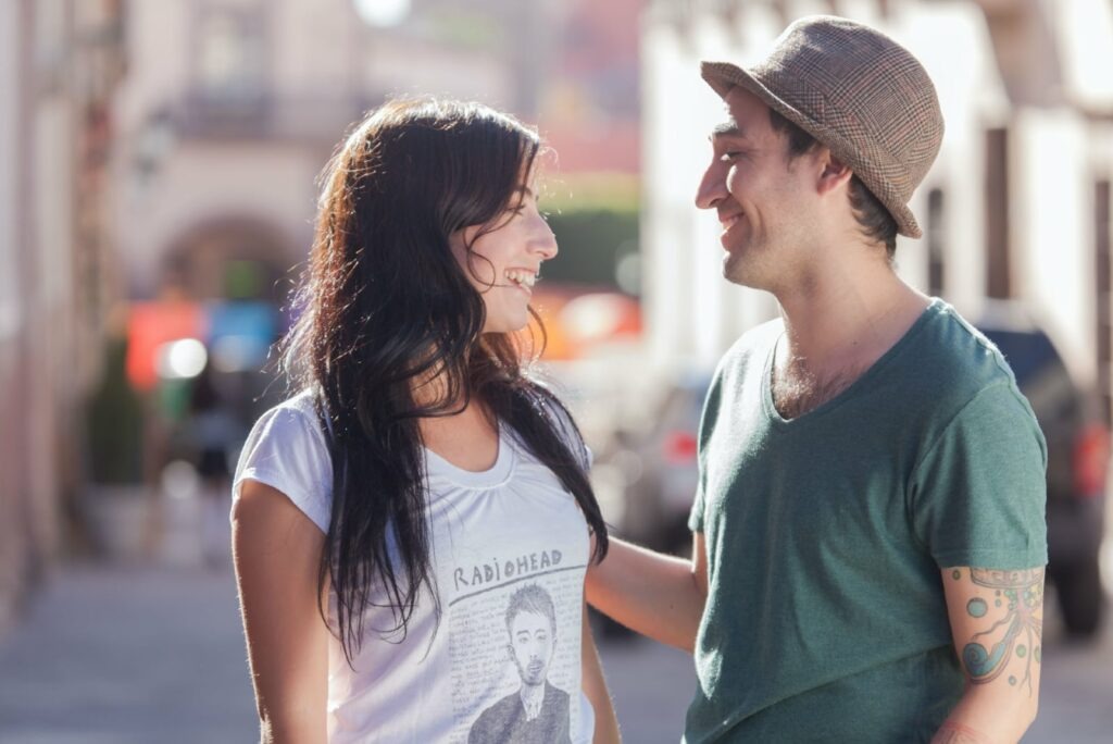 smiling man looking at woman