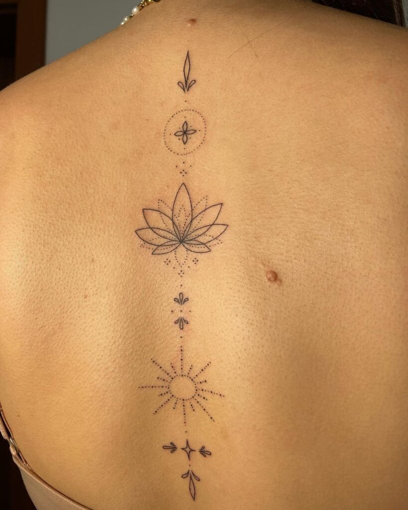 sun lotus ornamental spine tattoo