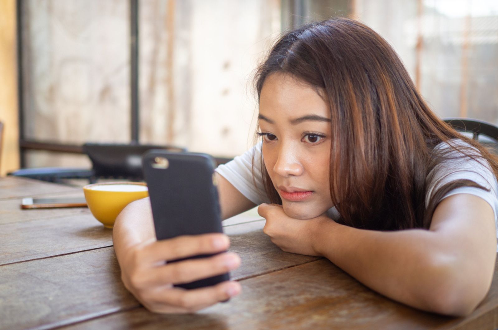 giovane donna preoccupata che guarda il telefono