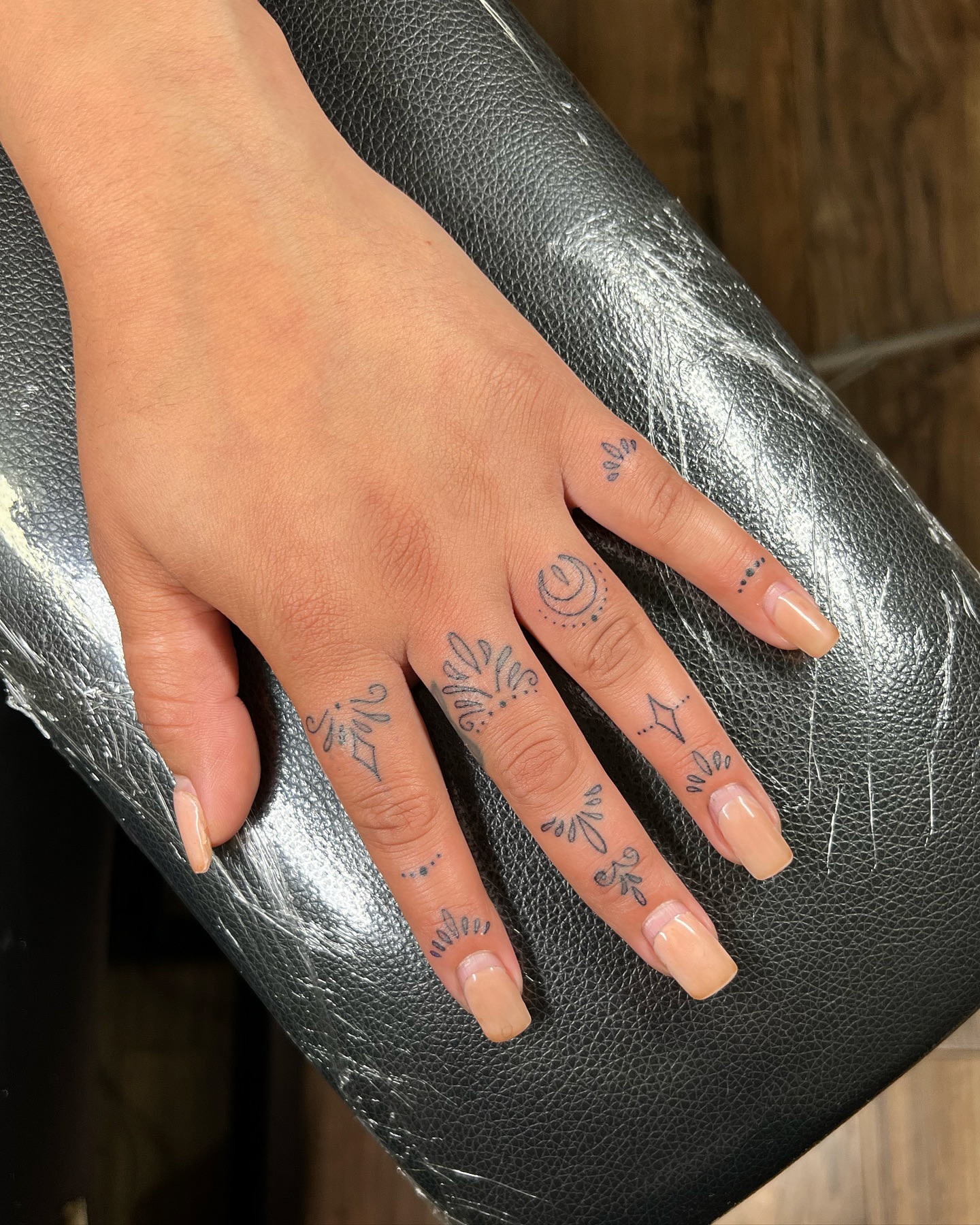 jewelry-inspired finger tattoos