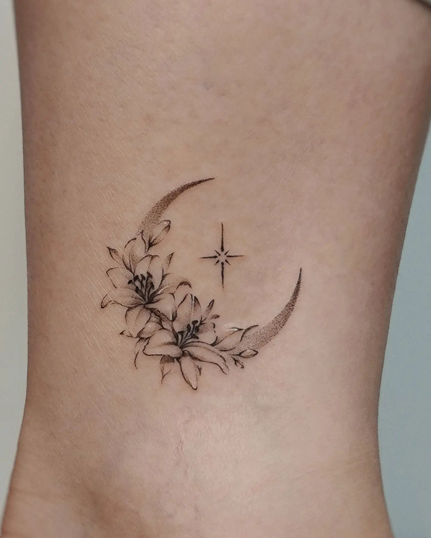 moon and flowers tattoo