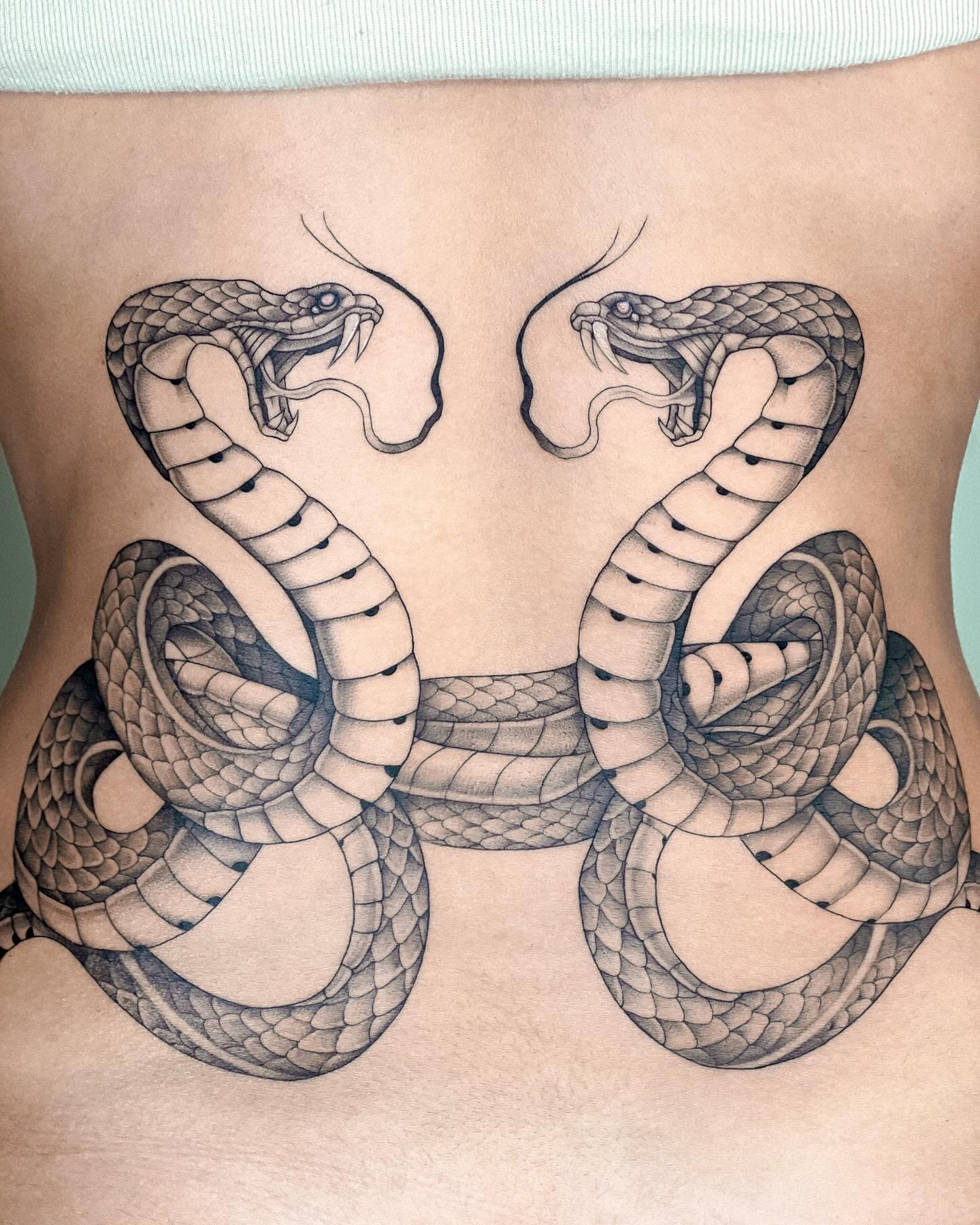 intertwined snakes tattoo