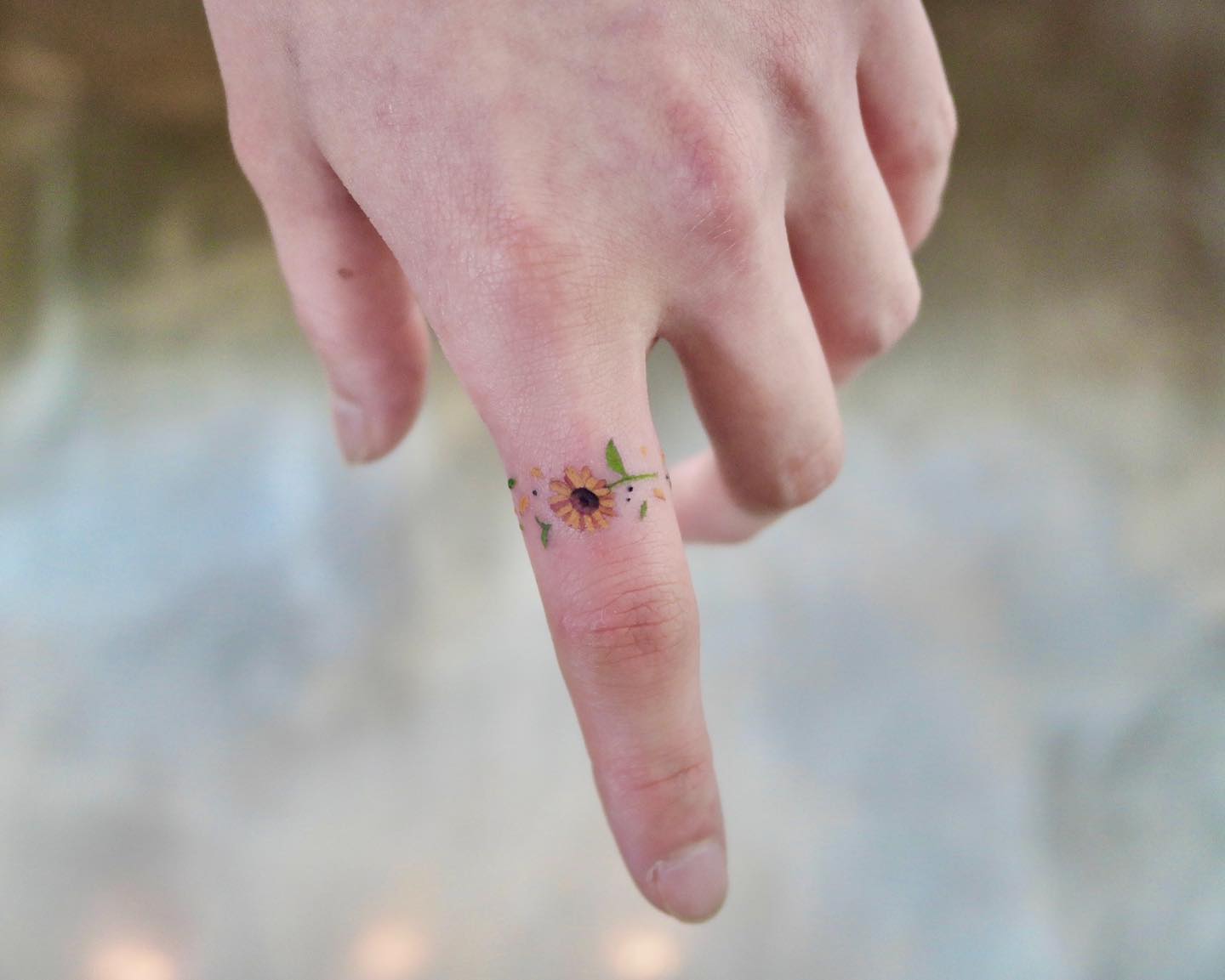 sunflower finger tattoo