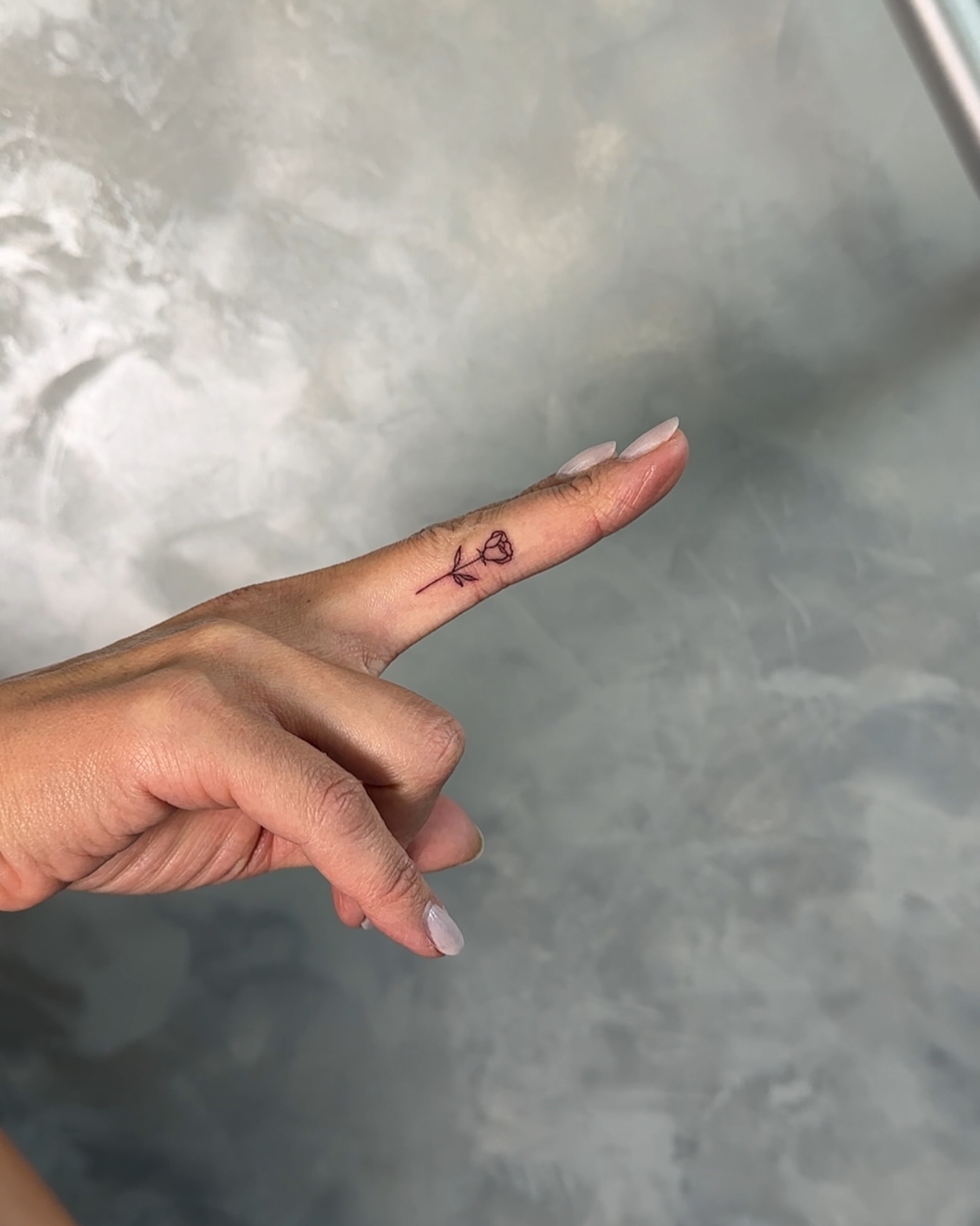 rose finger tattoo