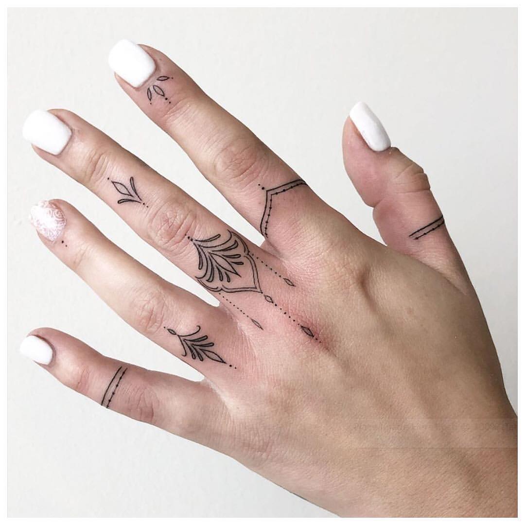 ornamental finger tattoos