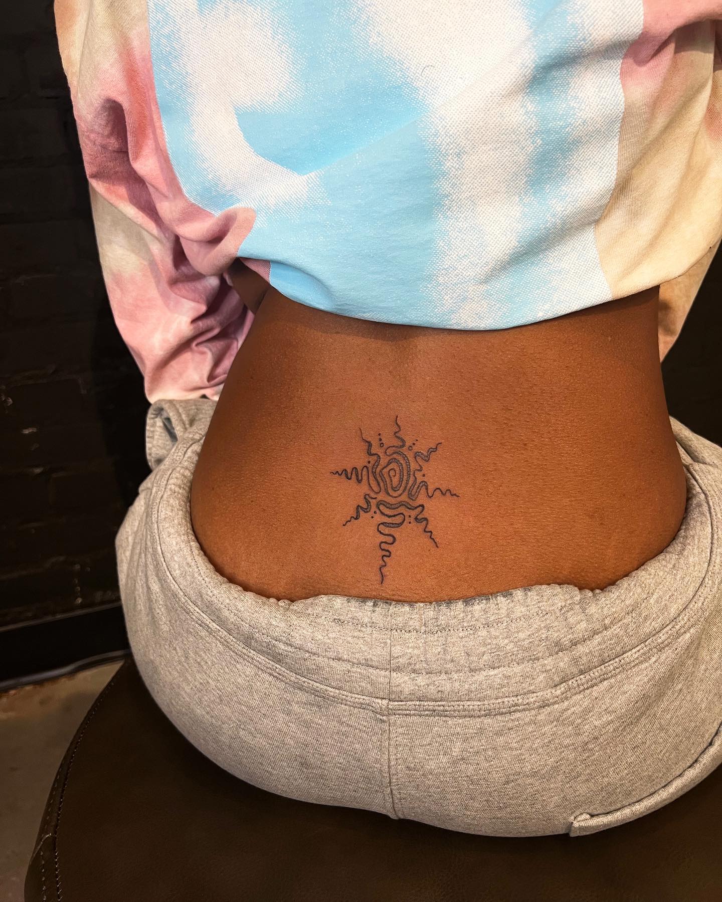 abstract lower back tattoo