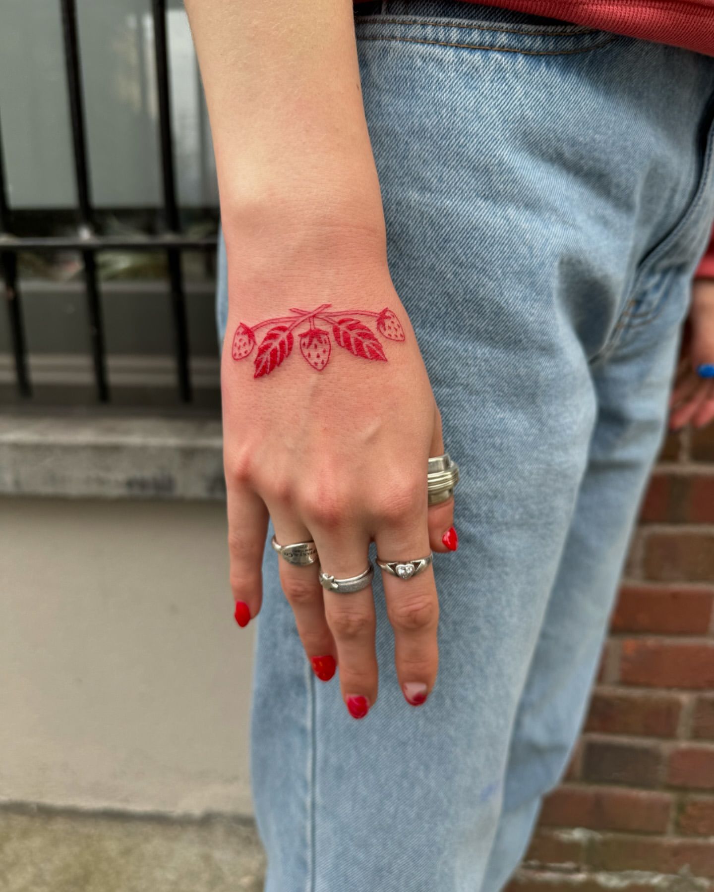 strawberry hand tattoo