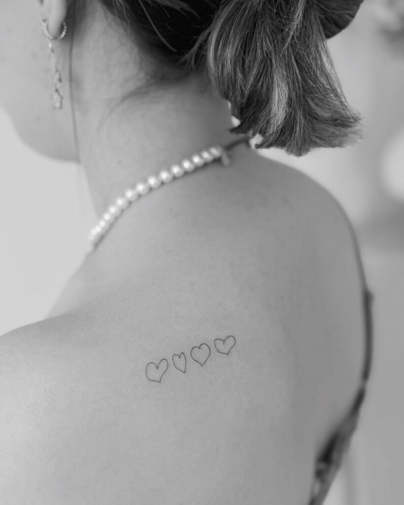 Four Tiny Hearts Back Tattoo