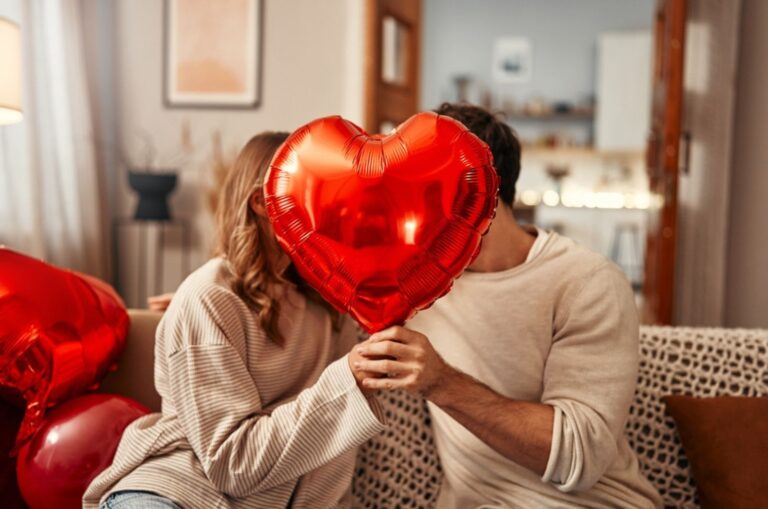 couple holding a heartshaped balloon