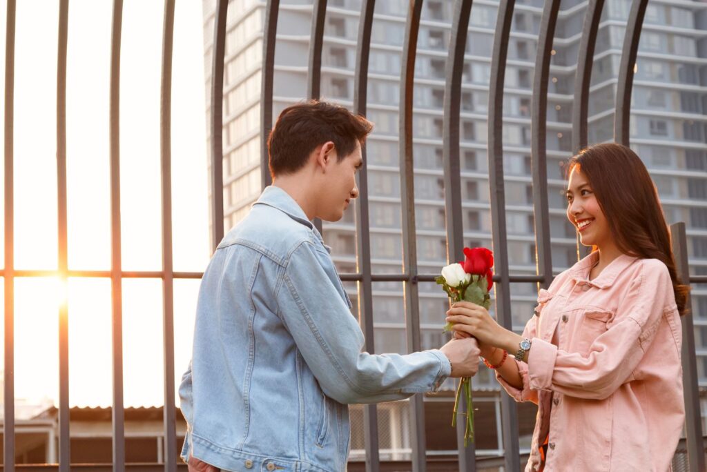 a man gives a flower to a woman on the street