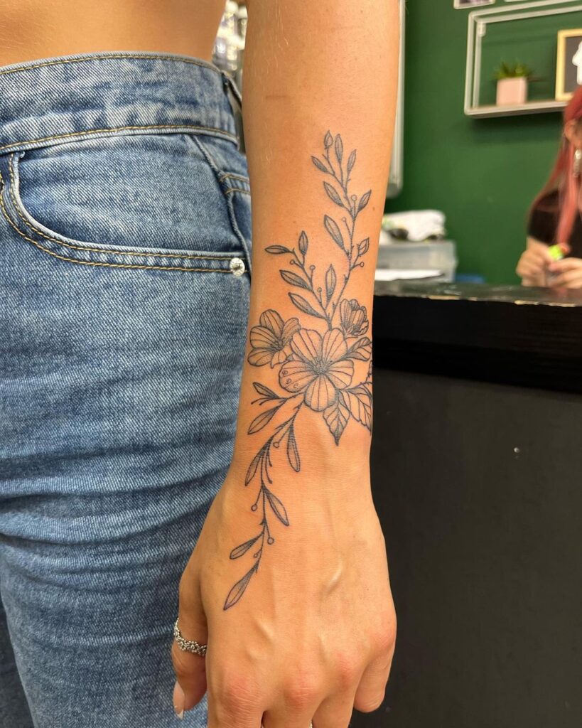 blackwork floral wrist tattoo