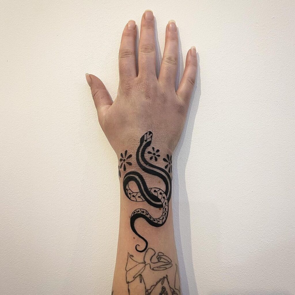 floral snake wrist tattoo design