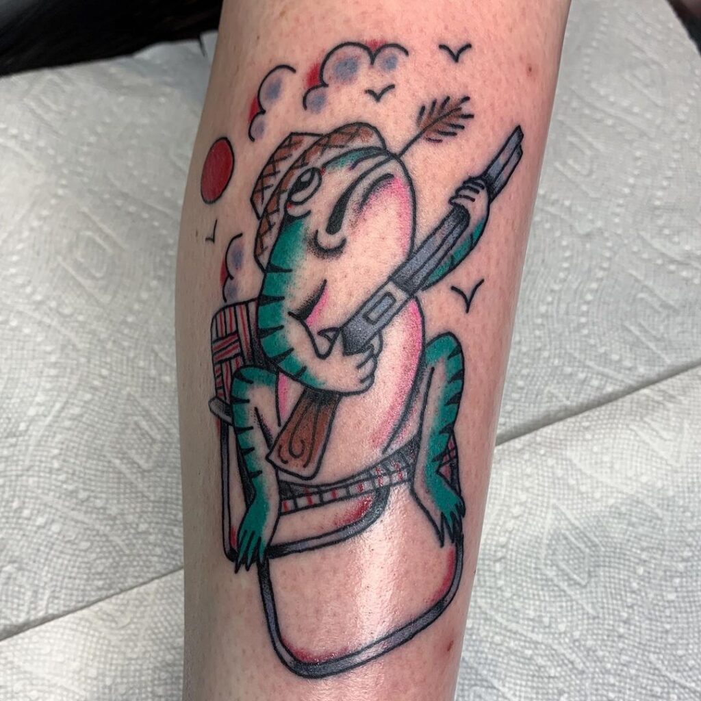 frog sitting on a lawn chair holding a shotgun funky tattoo