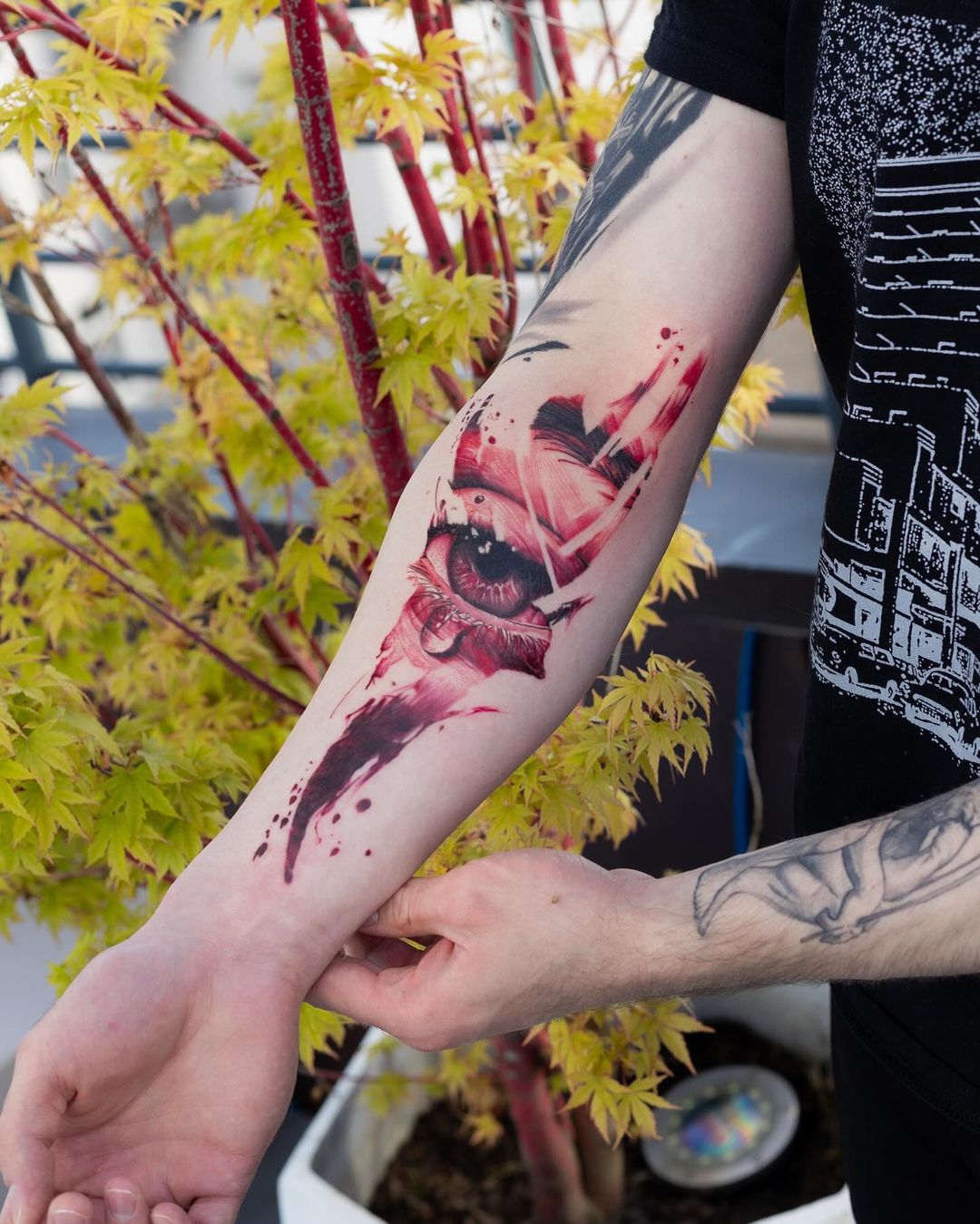 red eye forearm tattoo