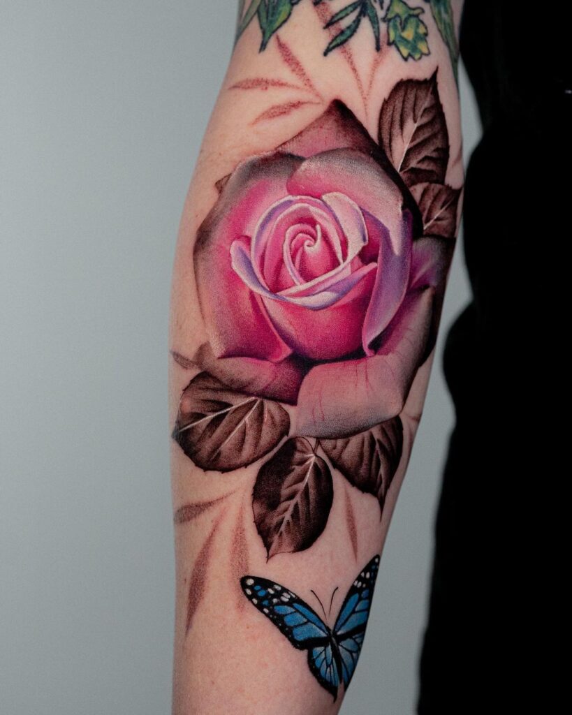 rose color arm tattoo