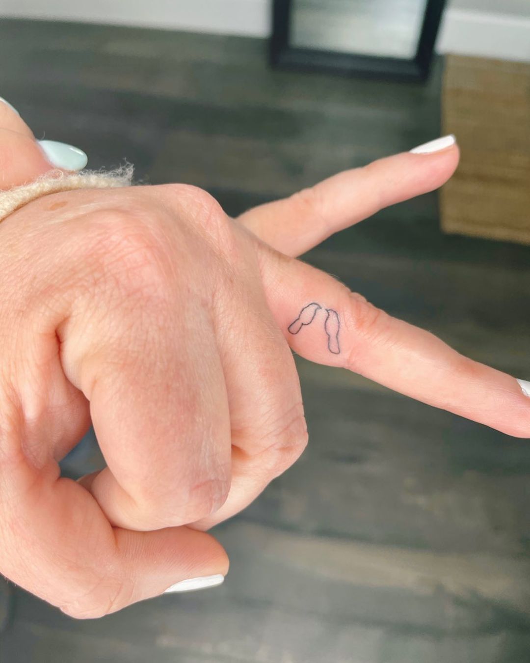 small birds ring finger tattoo