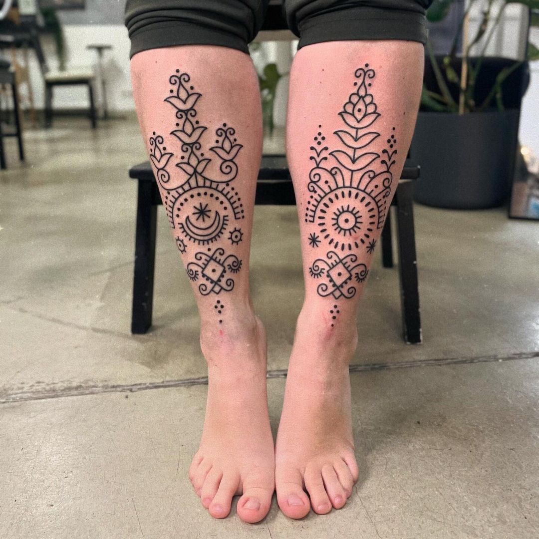 sun and moon ornamental floral leg tattoos