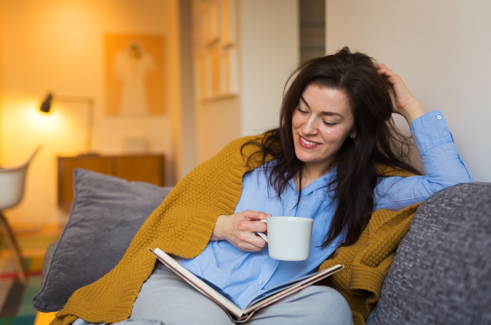 woman drinking tea and reading a book