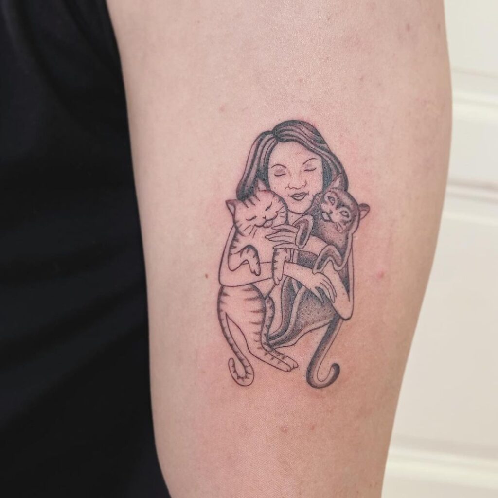 Tattoo Of Owner With Cats