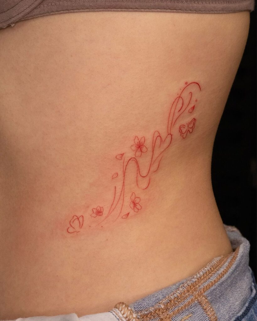 Delicate Red Ink Tattoo