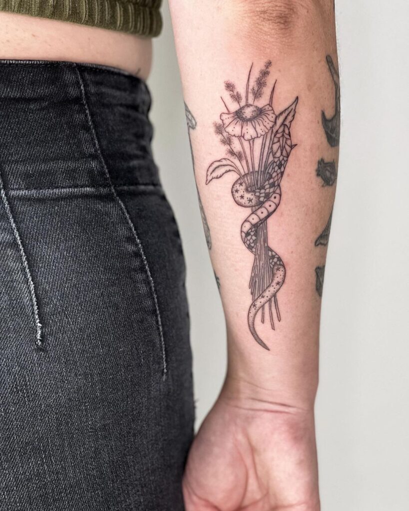 Serpent Wrapped Around Flowers Tattoo