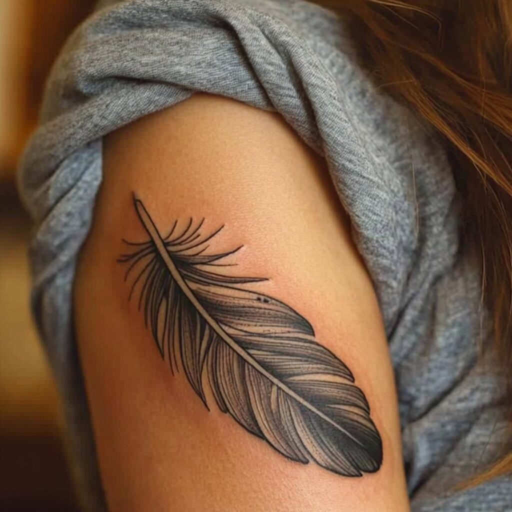 Black And Grey Arm Feather Tattoo