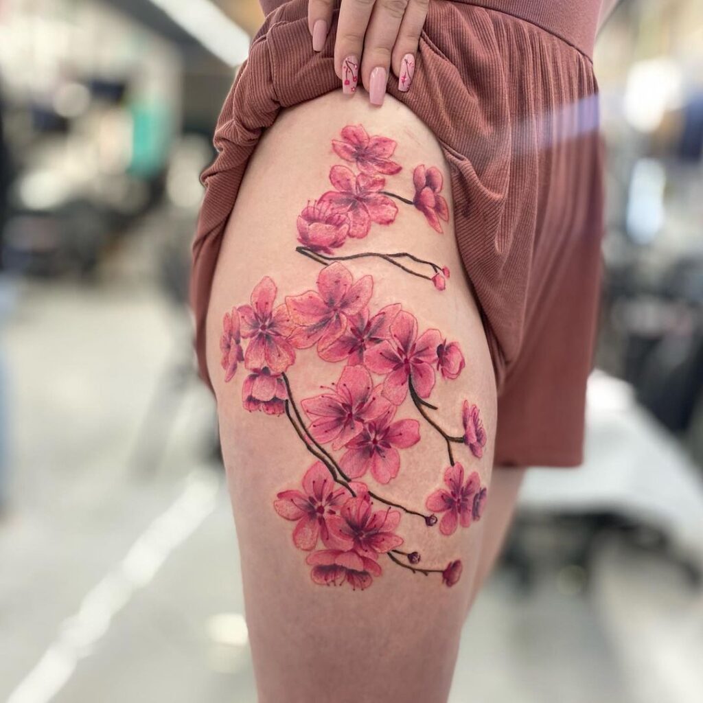 Tatuaje de flor de cerezo en el muslo