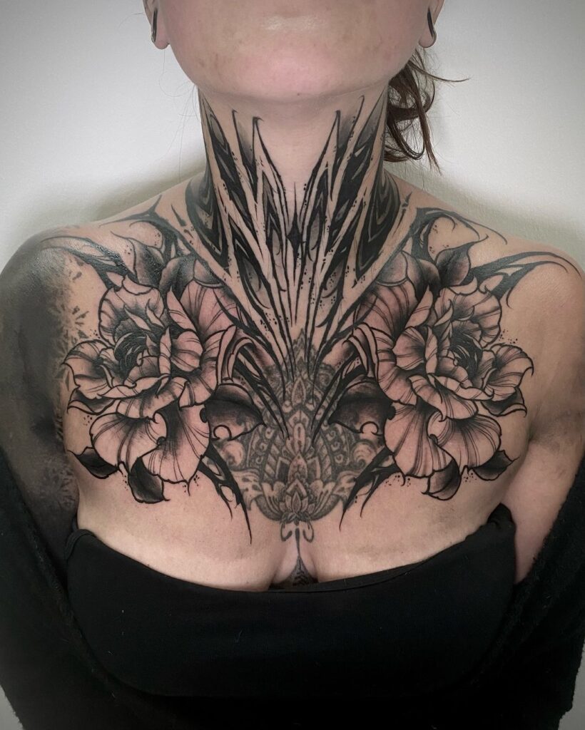 Dark Ornamental Chest And Neck Tattoo