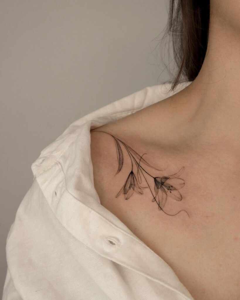 Fine Line Lily Collarbone Tattoo