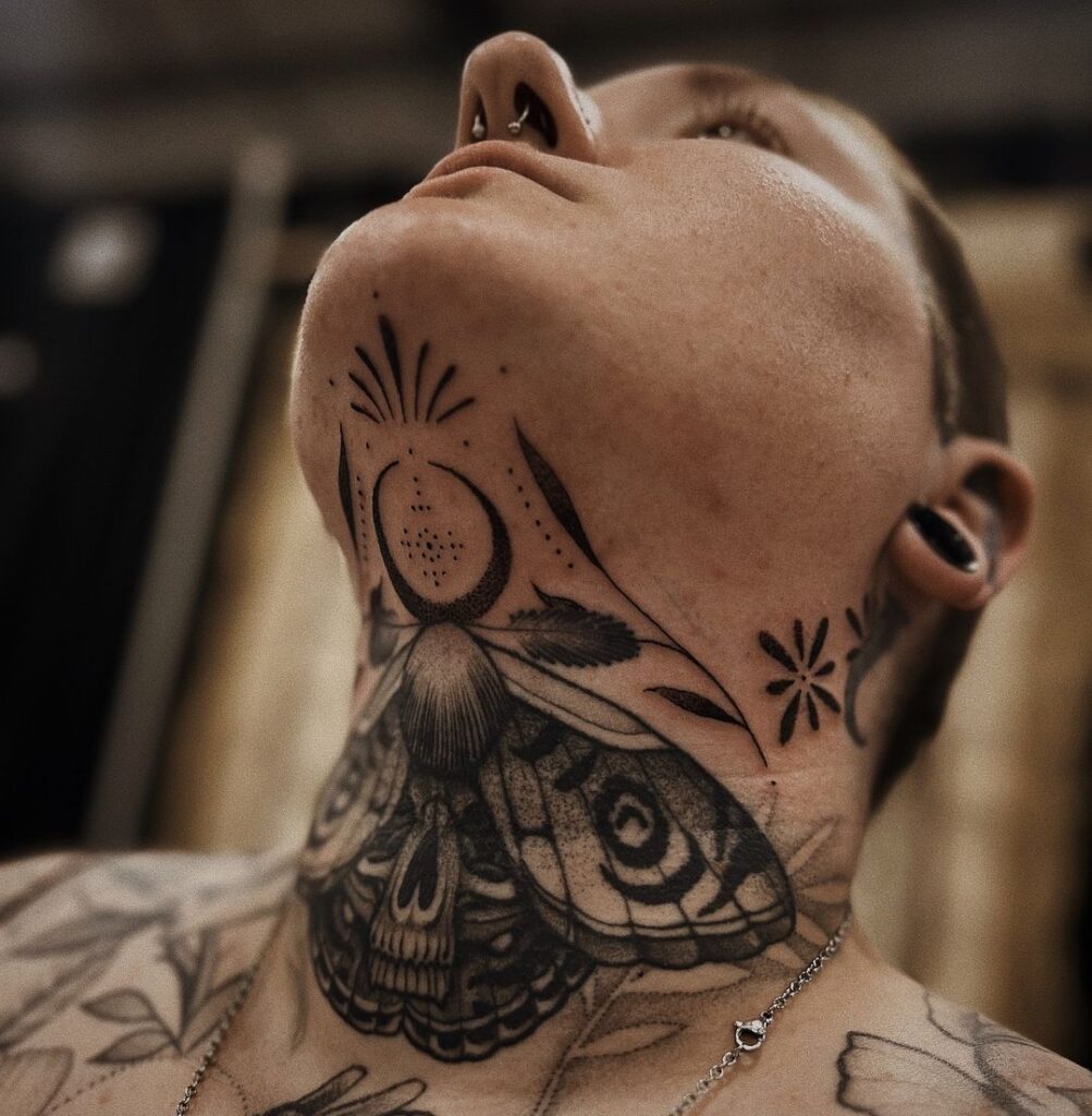 Moth Neck And Throat Tattoo