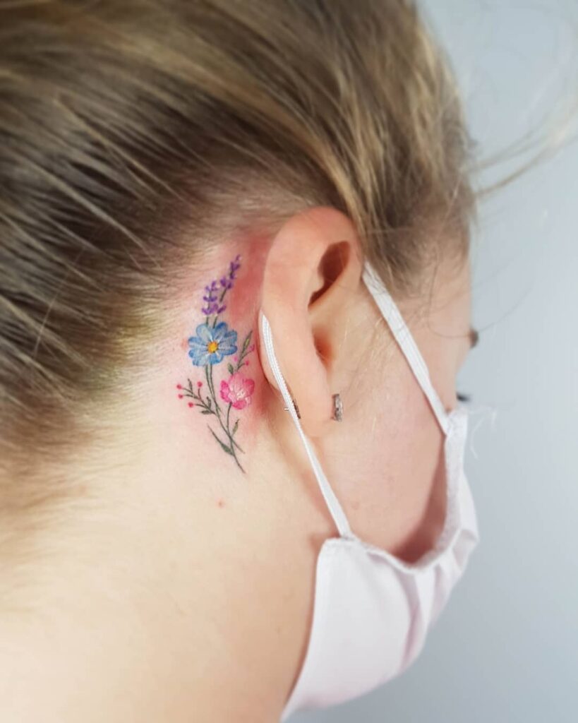 Tiny, Colorful Wildflowers Behind The Ear Tat