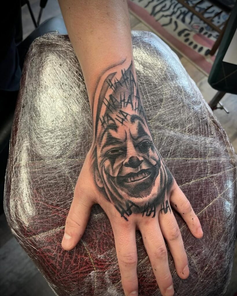 Joker Black And Grey Hand Tattoo