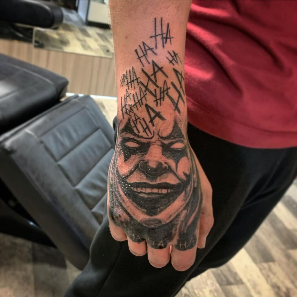 Joker's Laughter Hand Tattoo