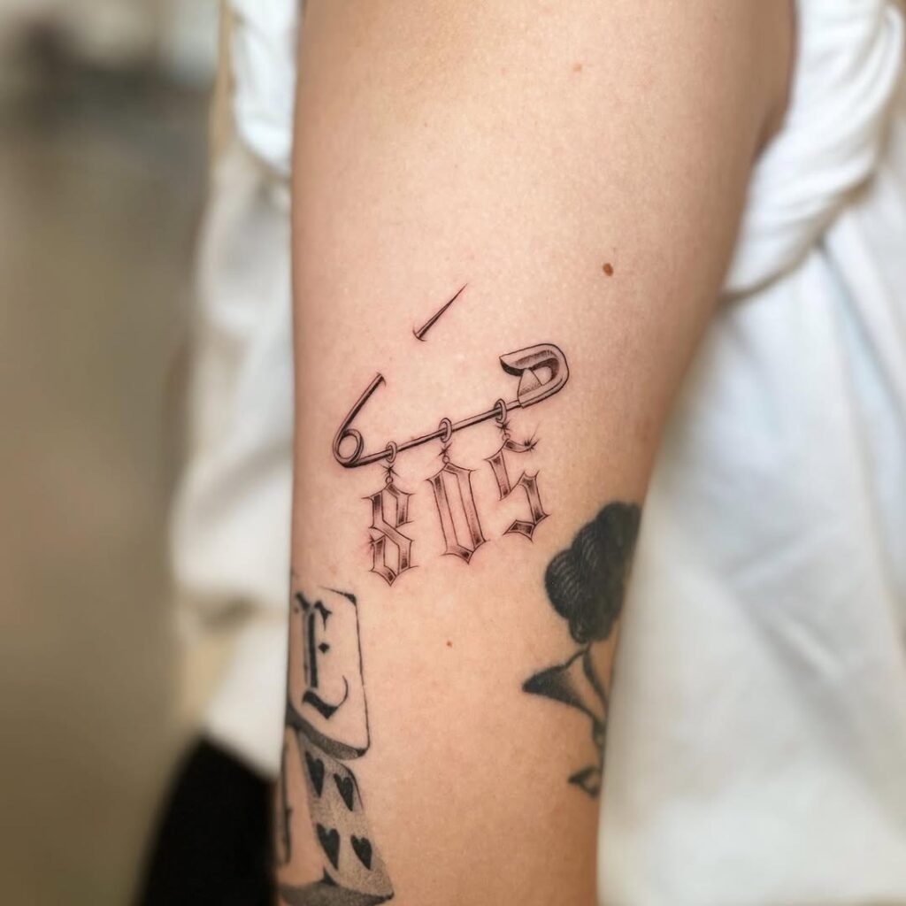 Safety Pin And Number Tattoo