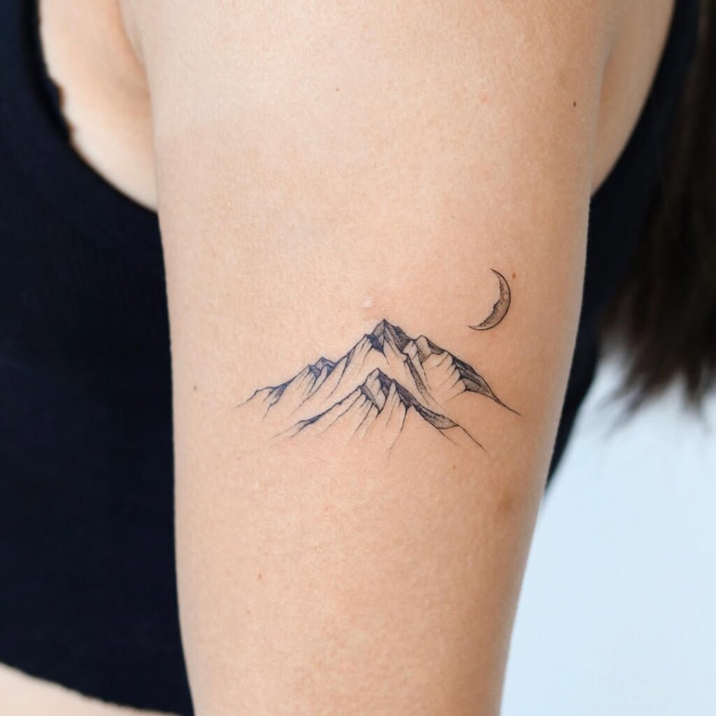 Tatuaggio con luna crescente e montagna